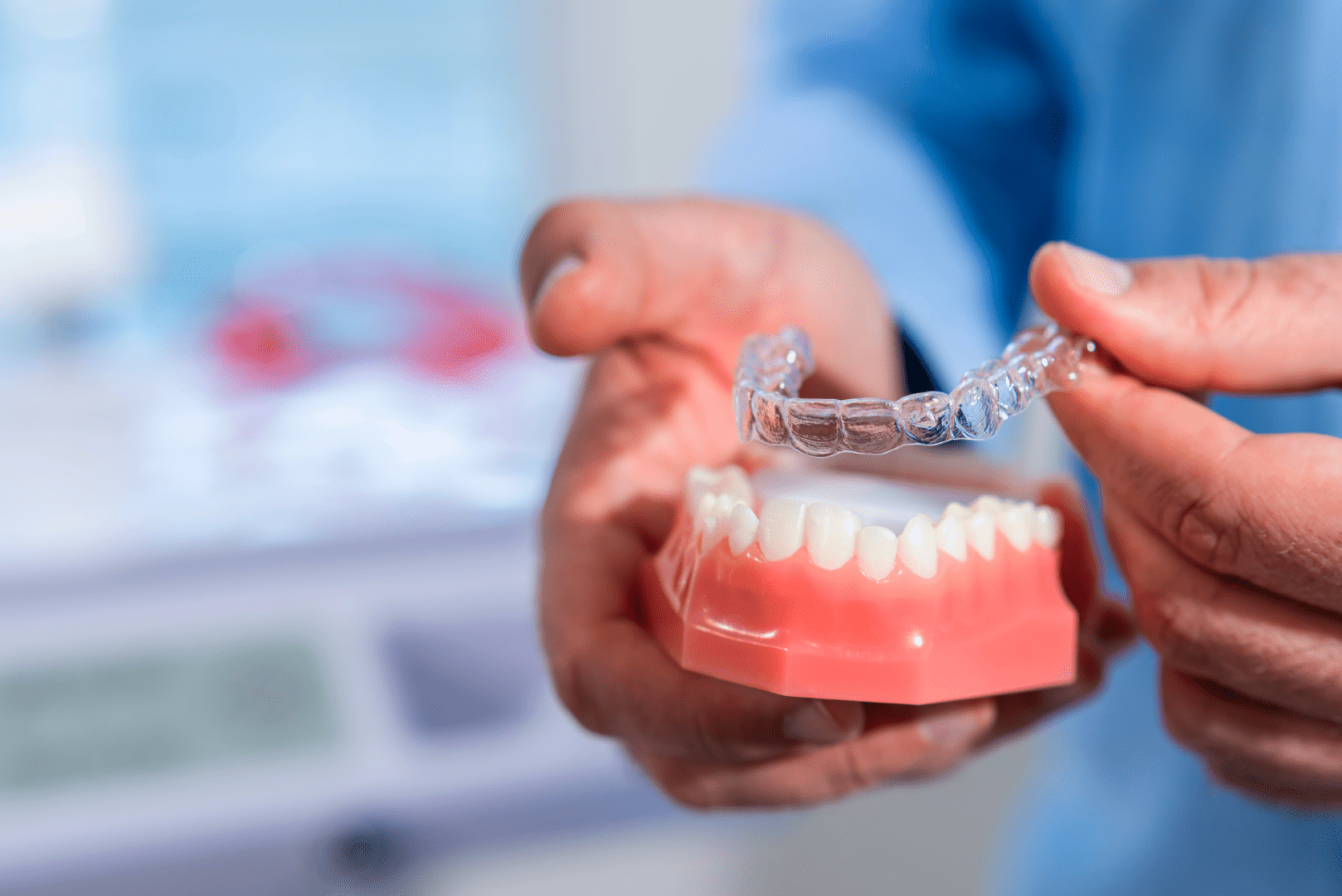 Dentist showing invisalign over a teeth model